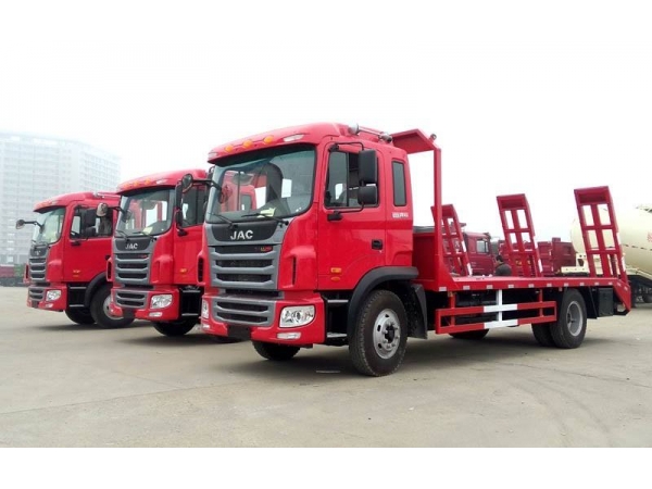 How an excavator be loaded on to a flat bed truck?